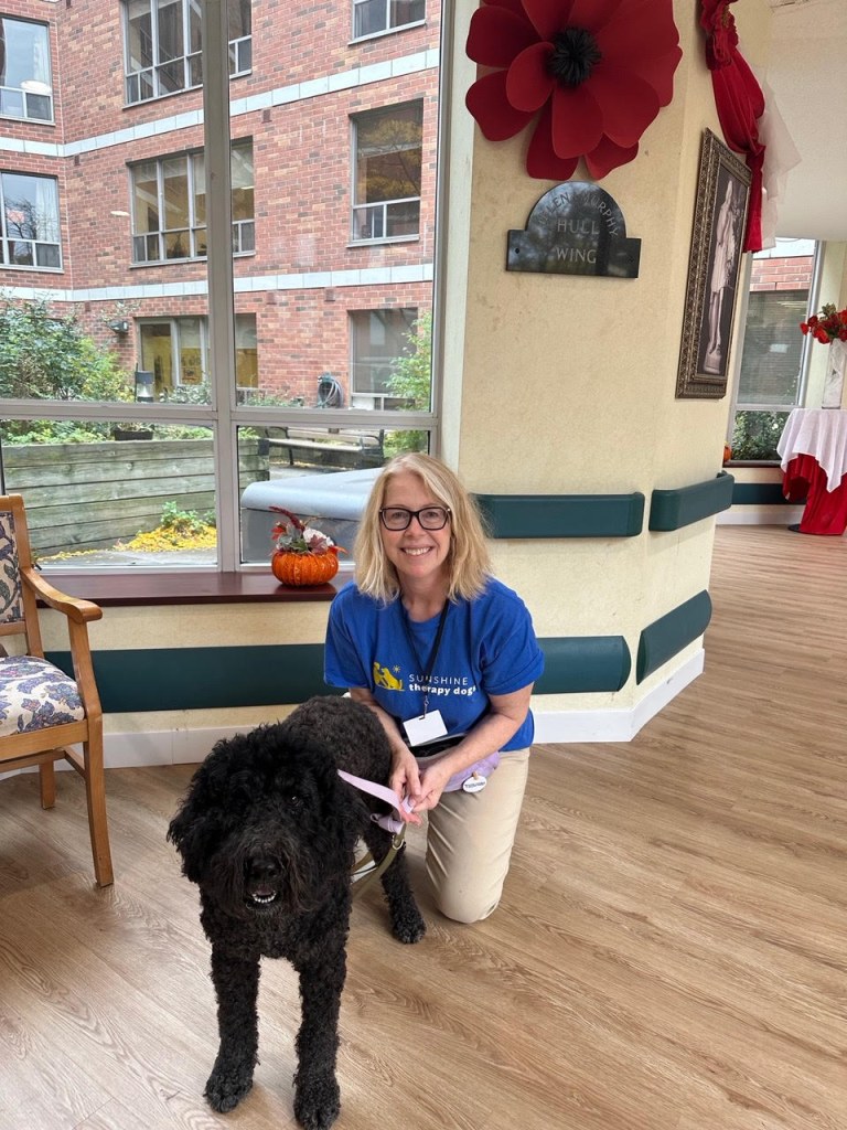 Vera volunteering with her dog Leila at Copernicus Lodge